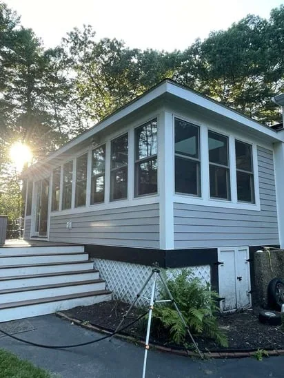 Hardie Plank siding Andover MA wrapped around a sunroom extension.