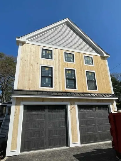 Final result of the exterior wood siding Lunenburg MA project above the two-car garage with all scaffolding removed.