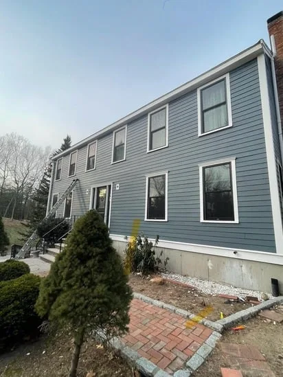 Full front facade perspective of a home exhibiting professional workmanship on blue fiber cement Hardie Plank Siding Andover.