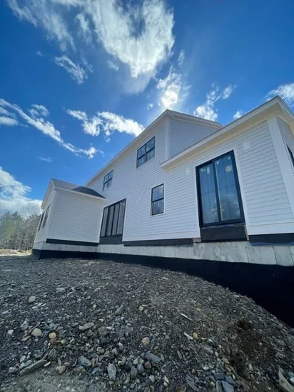 An expansive low-angle shot of the Hardie siding project in York, focusing on the newly sided rear exterior and a large glass door.