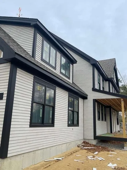 Detailed view of upper-level window trim and the Ogunquit cedar siding installation.